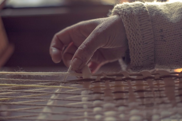 cropped hand woman weaving warm clothing 1048944 6987636